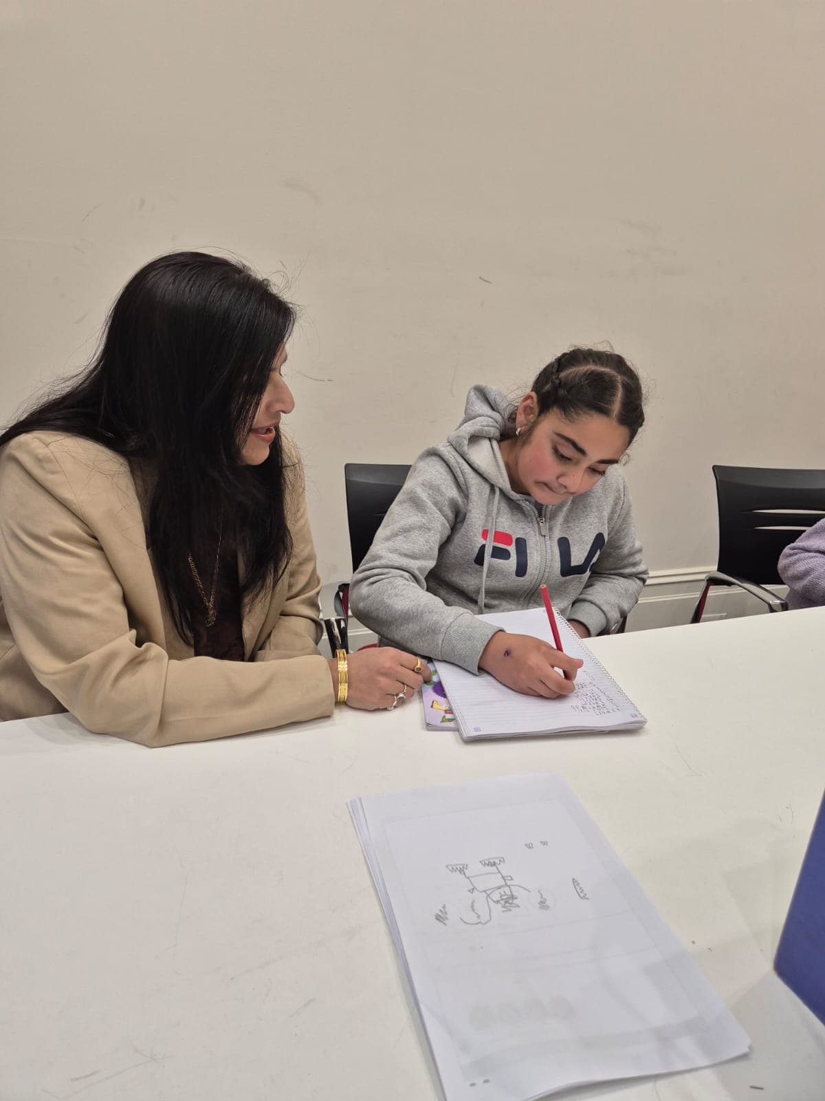 Student writing during a tutoring session